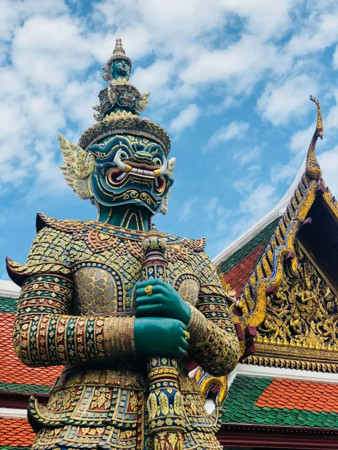 gold and blue dragon statue under blue sky during daytime